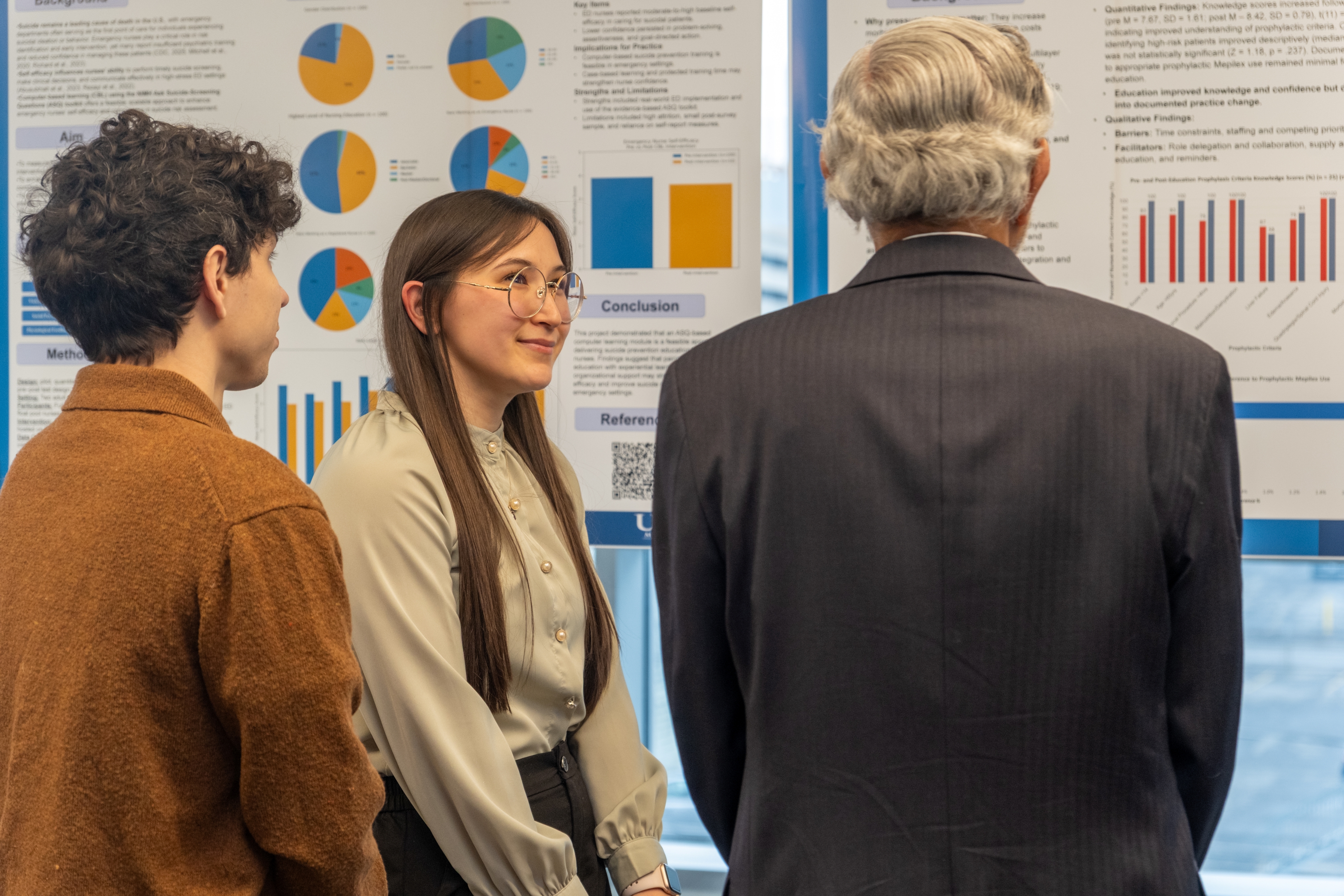 Dr. Dewan looks on at a presentation by a DNP Candidate