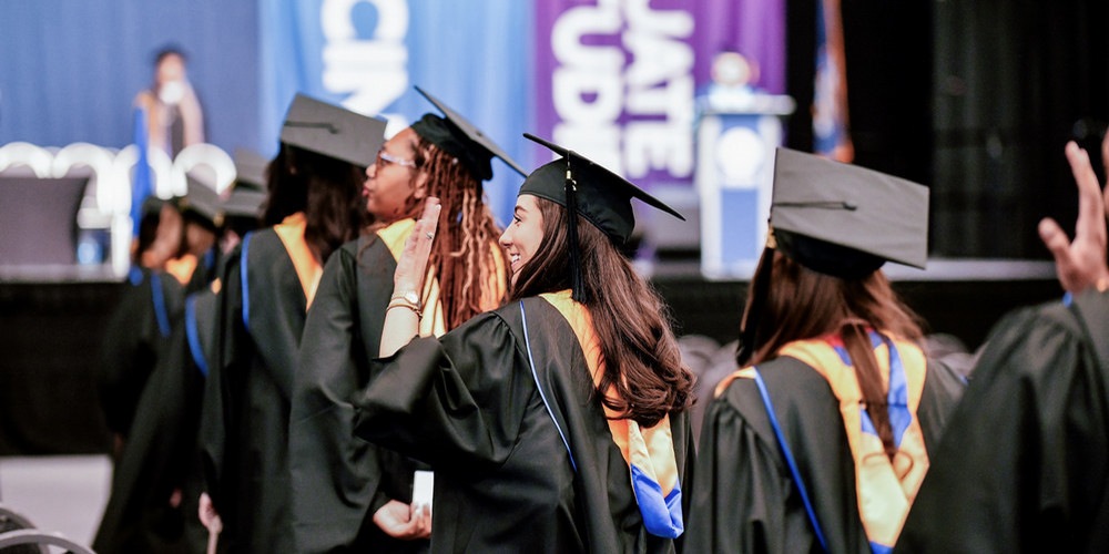 Behavior Analysis Studies, MS students, process towards the stage during SUNY Upstate Medical University's 2026 Commencement
